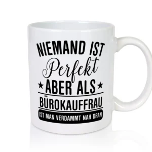 Verdammt nah dran: Bürokauffrau | Kauffrau - Tasse Weiß - Kaffeetasse / Geschenk / Familie